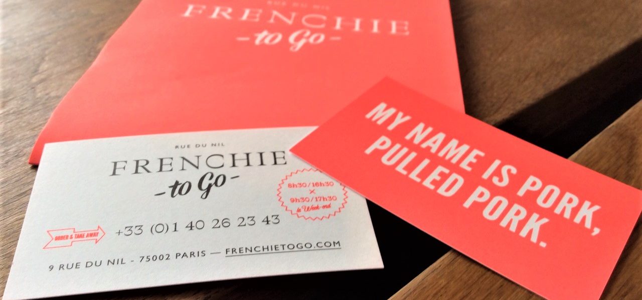 תקריב של שלושה פריטי נייר על משטח עץ: תפריט עם 